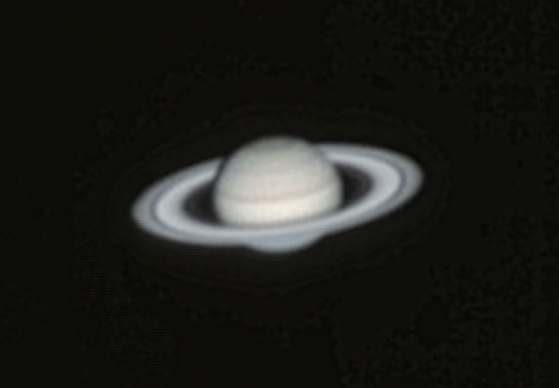 Saturn with tilted rings and cloud bands on a black background.