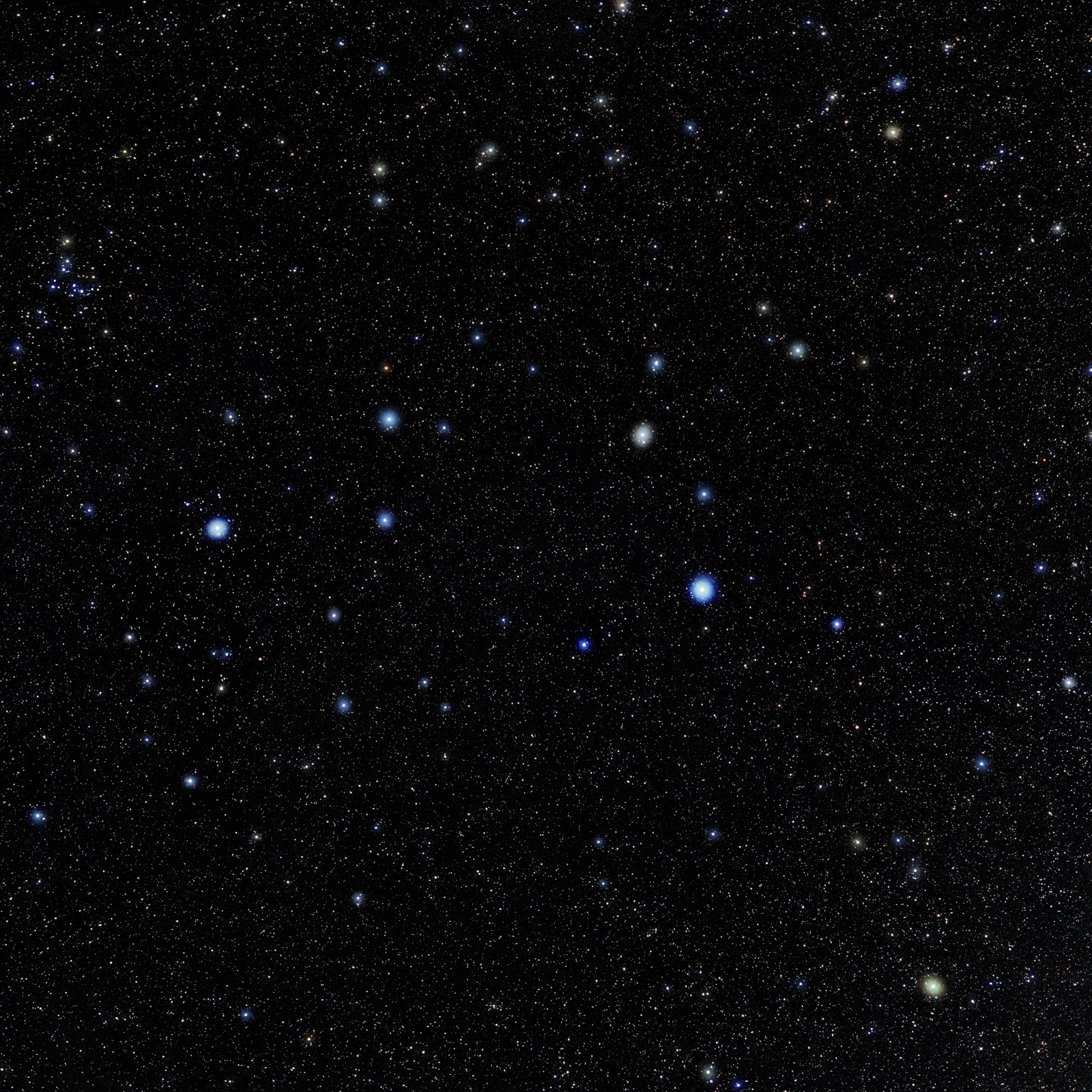 Star field of the constellation Leo with a few bright blue-white stars on a black sky.