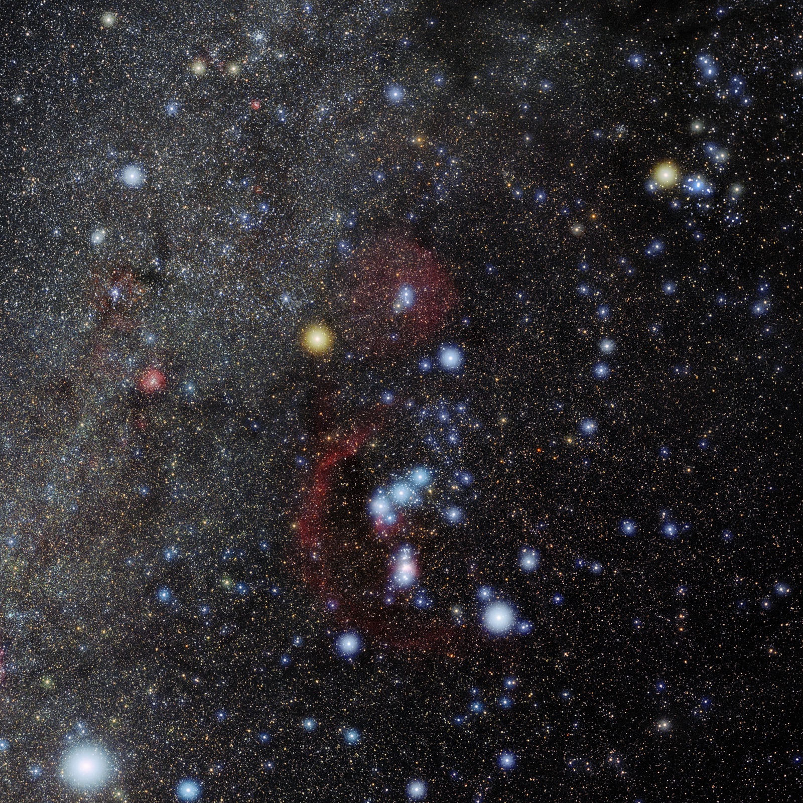 The constellation Orion with an orange star upper left, blue-white star lower right and red nebulosity.